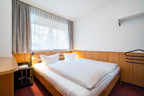 Postel nebo postele na pokoji v ubytování Gorch-Fock-Park App 3