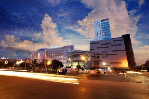 a city with buildings and a street with lights at Hotel Horison Ultima Bekasi in Bekasi