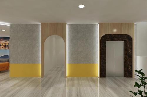 a room with a hallway with yellow and gray walls at All Nite & Day Sulsel -Makassar in Makassar