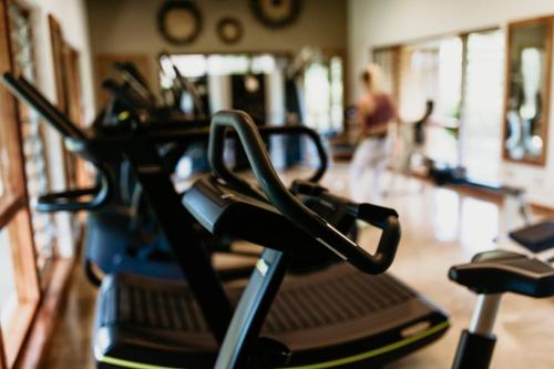 a close up of a gym with a row of exercise bikes at The Makokola Retreat in Mponda