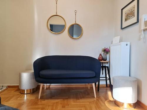 a blue couch in a living room with a table at Simple & Noble in Athens