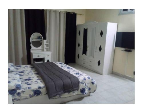 a bedroom with a bed and a dresser and a mirror at Mini studio meublé à Ngor in Ngor