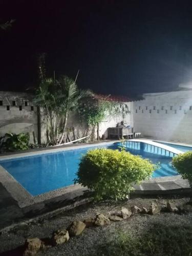 a blue swimming pool at night with a building at Lugar encantador con alberca in Chiapa de Corzo