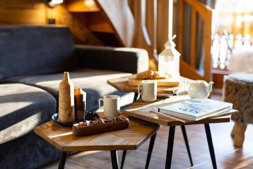 a living room with two tables and a couch at Hôtel et Spa Le Vermont in Le Grand-Bornand