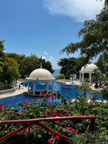 a garden with a gazebo and flowers at Sky Beach Pattaya in North Pattaya