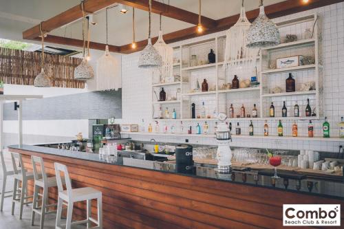 a bar in a restaurant with chairs and bottles at Combo Beach Hotel Samui in Chaweng