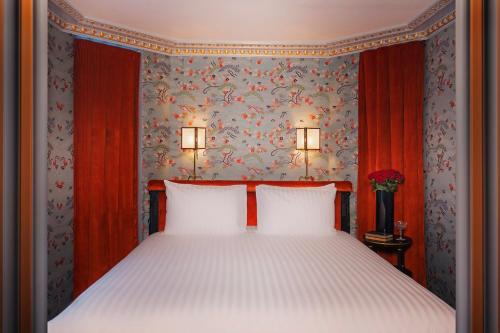 a bedroom with a bed with two white pillows at Maison Proust, Hotel & Spa La Mer in Paris