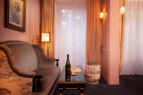 a living room with a couch and a table at Maison Proust, Hotel & Spa La Mer in Paris