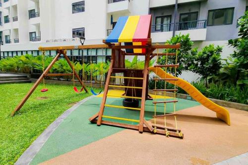 a playground with a slide in front of a building at Fully furnished 1-BR Condo Unit at Spring Residences in Manila