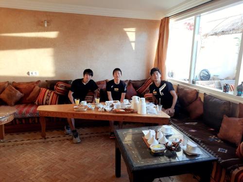 a group of men sitting around a table in a living room at Dar Rio Oro in Dakhla
