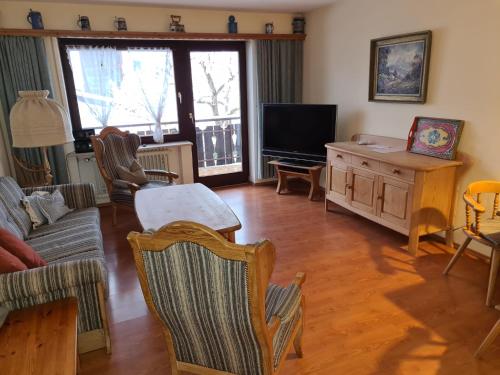 a living room with a couch and a tv at Bergdiamant in Garmisch-Partenkirchen