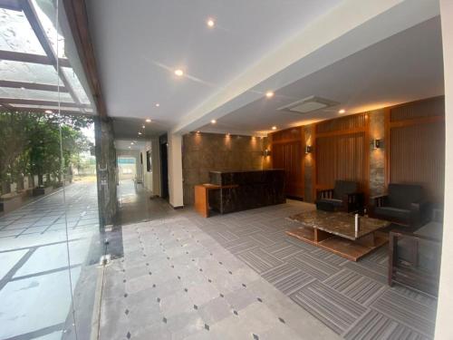 a lobby of a building with chairs and tables at SHLOKA RESIDENCY in Shamshabad