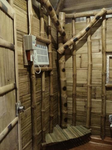 a room with a wooden wall with a air conditioner at D Sanctum Resort in General Santos