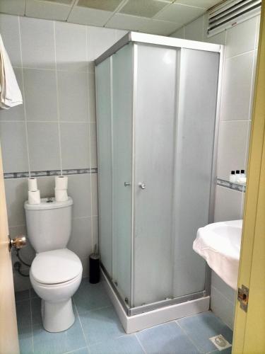a bathroom with a toilet and a shower and a sink at Rıdvan Hotel in Cesme