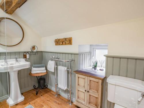 a bathroom with a sink and a mirror at Hob Cote in Heptonstall