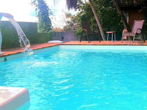 a swimming pool with a fountain in the middle at Pousada Bodega da Terra in Pirangi do Norte