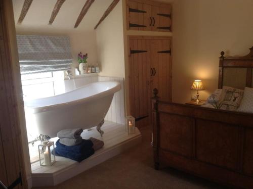 a bathroom with a bath tub in a room at Beautiful Stone Riverside Cottage in Waterfall