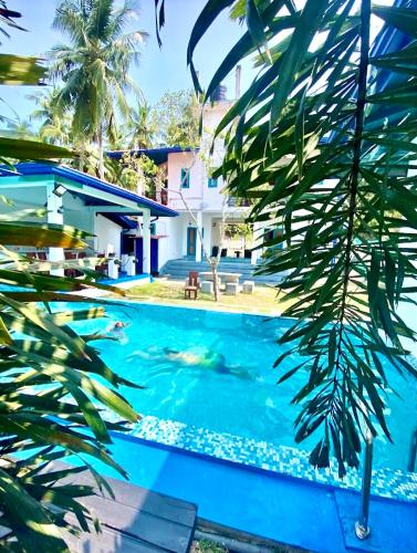 a swimming pool in front of a house at Seth Villa by Magampura Resorts in Tangalle