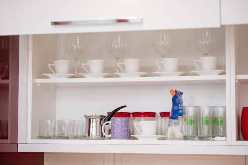 a cabinet filled with cups and plates and glasses at Loft2 in Kolašin