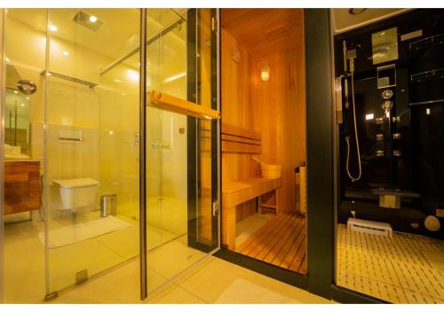 a glass shower in a bathroom with a toilet at Chandys Drizzle Drops - Munnar Top Station in Munnar