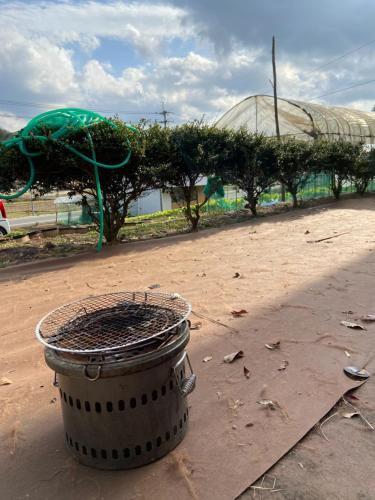 a trash can sitting in the middle of a field at 古民家HAKKOU kibi 