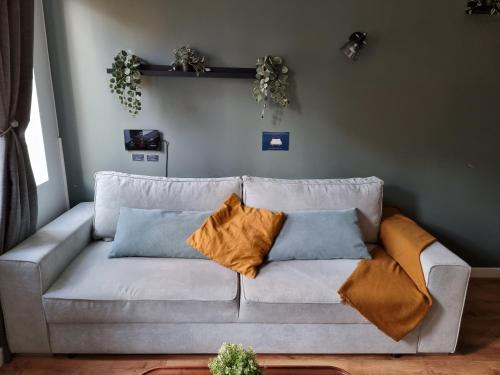 a white couch with pillows on it in a living room at Travel Homes - The Parc, next to Champ de Mars in Colmar