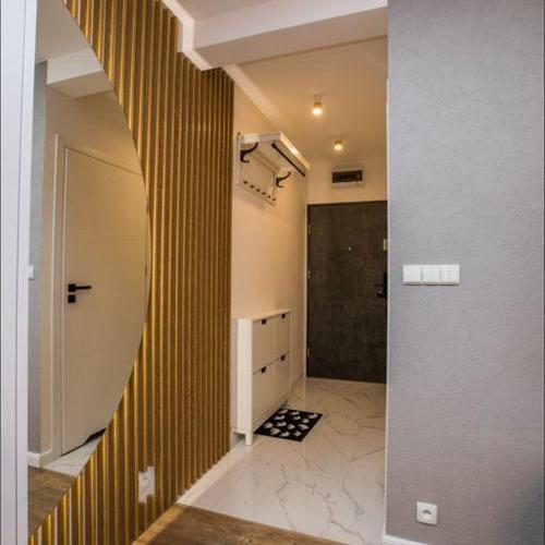 a hallway with a staircase in a house at Apartament na wynajem 32 m2 in Bochnia
