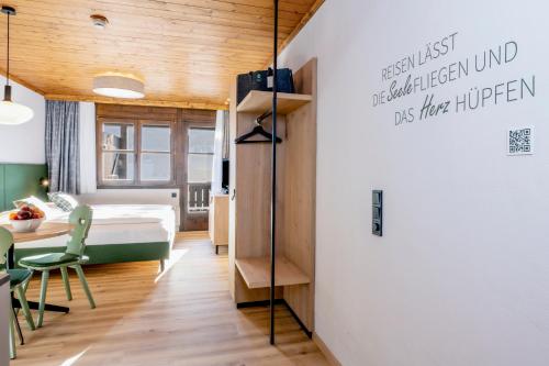 a bedroom with a bed and a desk in a room at Hapimag Ferienwohnungen St Michael in Sankt Michael im Lungau