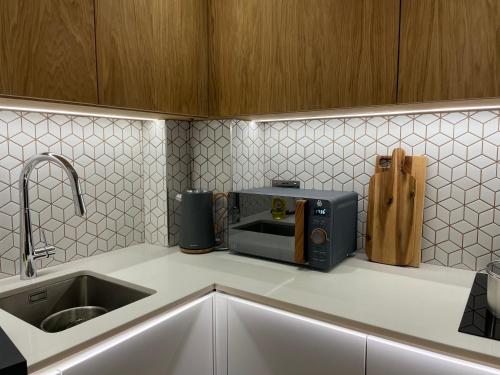 a kitchen with a counter top with a toaster at Magi - Apartment with balcony in Jahorina