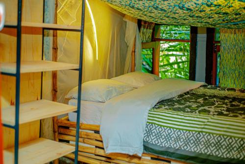 a bedroom with a bunk bed and a window at Fravan Eco Resort By Apogee in Ruhengeri