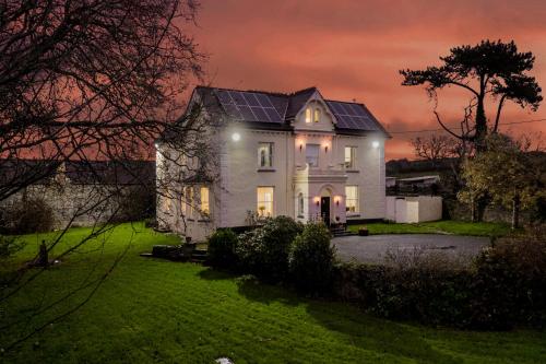 a house with solar panels on the roof at night at Caemorgan Mansion in Cardigan