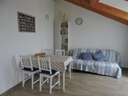 a room with a table and chairs and a bed at Ca' du riàn in Loano