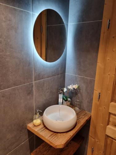 a bathroom with a sink and a mirror on a wall at Chalet le Petit Ramoneur in Châtel