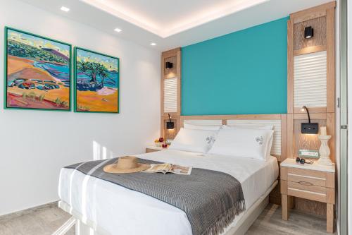 a bedroom with a bed with a hat on it at Mariet Naxos Elegant Suites in Naxos Chora