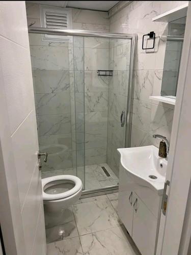 een badkamer met een douche, een toilet en een wastafel bij Şişli-Taksim in Istanbul
