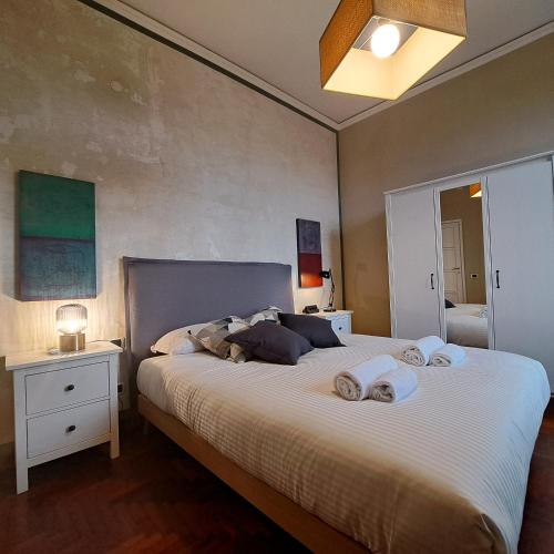 a bedroom with a large bed with towels on it at Apartment Corsica 11 in Florence