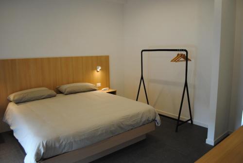 a bedroom with a bed and a lamp in it at Hotel La Tavernetta in Campobasso