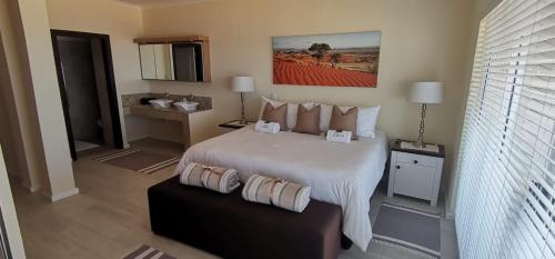 a hotel room with a large bed with two boxes on it at 25 Sunset View in Langstrand