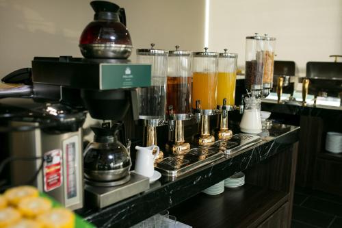 a counter with a bunch of different types of drinks at Hanoi L'Heritage Hotel & Gym - Spa in Hanoi