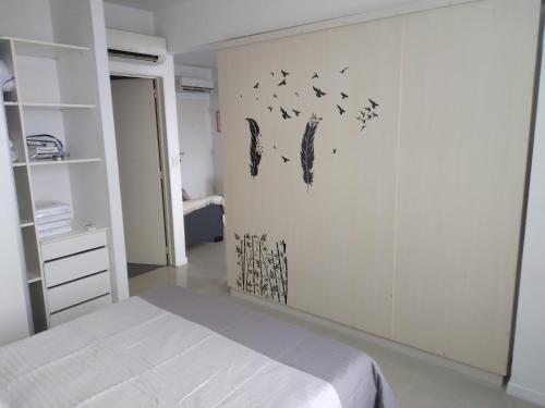 a bedroom with a bed and birds on the wall at STRADA II in Buenos Aires