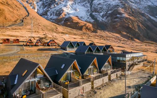 an aerial view of a resort with a mountain in the background at Kazbegi View Cottages in Stepantsminda