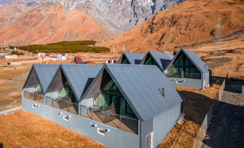 an overhead view of a house with mountains in the background at Kazbegi View Cottages in Stepantsminda