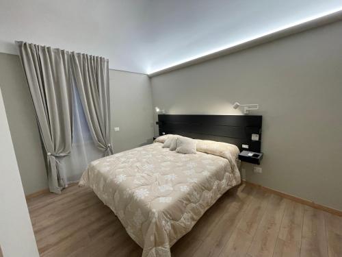 a bedroom with a bed and a large window at Appartamento Totò in San Salvo