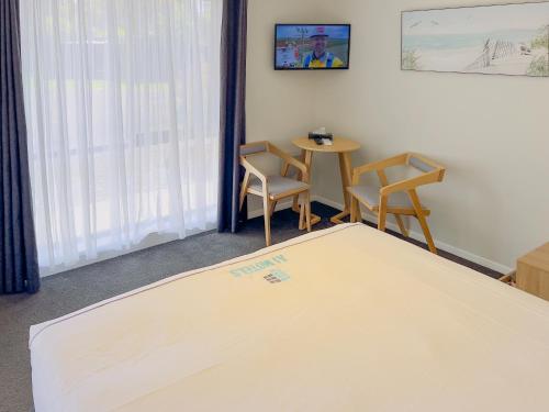 a room with a ping pong table and chairs at A1 Motels and Apartments Port Fairy in Port Fairy