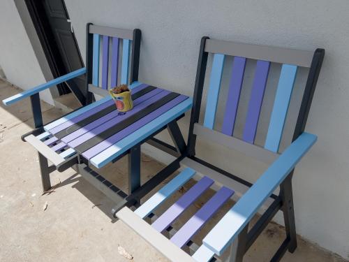 two blue chairs sitting next to a wall at A1 Motels and Apartments Port Fairy in Port Fairy