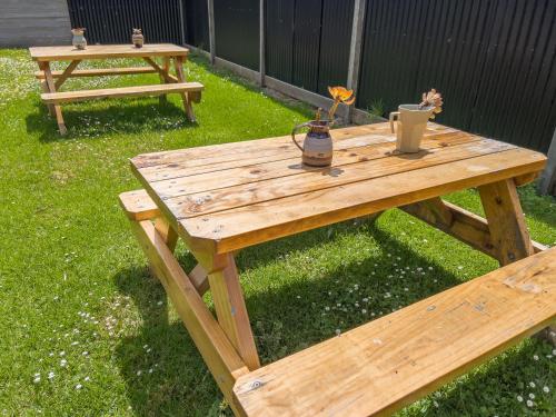 a wooden picnic table with flowers on top of it at A1 Motels and Apartments Port Fairy in Port Fairy