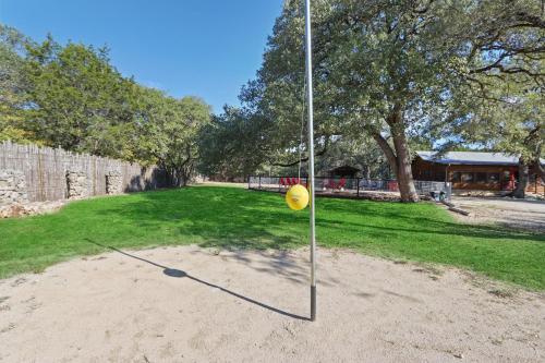 a yellow frisbee on a pole in the sand at Wimberley Log Cabins Resort and Suites- Unit 2 in Wimberley