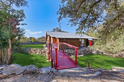 a red staircase leading to a log cabin at Wimberley Log Cabins Resort and Suites- Unit 1 in Wimberley