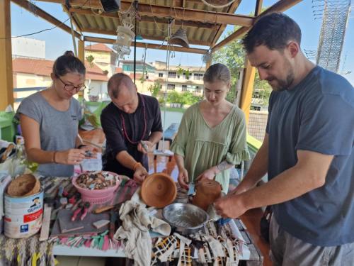 a group of people preparing food at a market at Karma Home Hostel in Phitsanulok