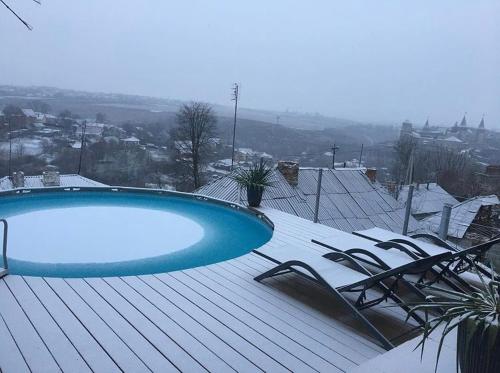a blue swimming pool on top of a roof at Tatsopus in Kamianets-Podilskyi